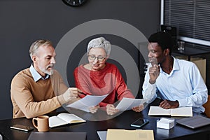 Business people with senior workers collaborating on project