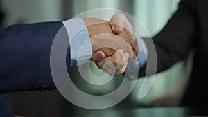Business people shacking hands together showing successful contract agreement