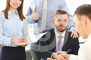 Business people shake hands ending meeting closeup