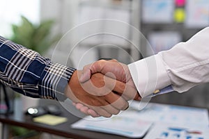 Business people shake hands to celebrate partnerships and business agreements. Effective communication and handshake concepts