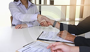 Business people shake hands to congratulate new employees in interviews after meeting in office