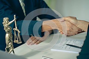 Business people shake hands to make an agreement male judge legal advisor A court litigation planning service contract after co-op