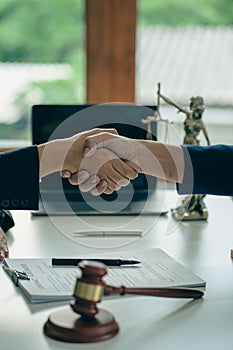 Business people shake hands to make an agreement male judge legal advisor A court litigation planning service contract after co-op