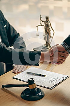 Business people shake hands to make an agreement male judge legal advisor A court litigation planning service contract after co-op