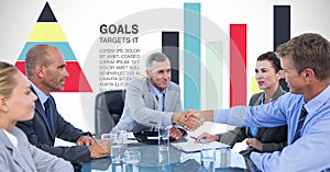 Business people shaking hands against graphs
