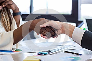 Business people shaking hands. Business man and business woman shaking hands during a meeting in the office