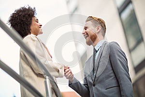 Business people shaking hands on city street