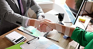 Business people shaking hands, completing signing of contract in office closeup