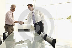 Business People Shaking Hands In Conference Room