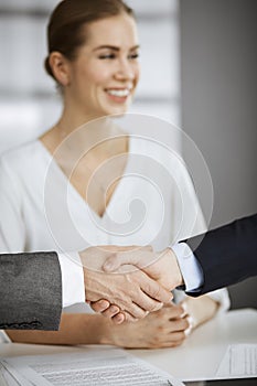 Business people shaking hands finishing contract signing, close-up. Business communication concept. Handshake and