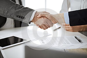 Business people shaking hands finishing contract signing, close-up. Business communication concept. Handshake and