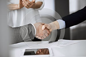 Business people shaking hands finishing contract signing, close-up. Business communication concept. Handshake and