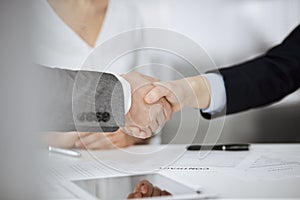 Business people shaking hands finishing contract signing, close-up. Business communication concept. Handshake and