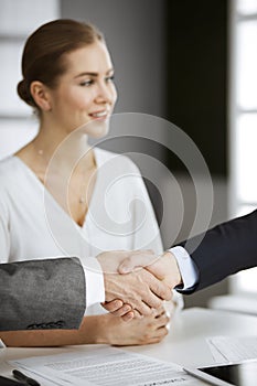 Business people shaking hands finishing contract signing, close-up. Business communication concept. Handshake and