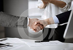 Business people shaking hands finishing contract signing, close-up. Business communication concept. Handshake and