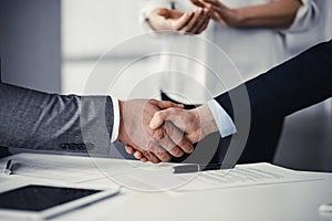 Business people shaking hands finishing contract signing, close-up. Business communication concept. Handshake and