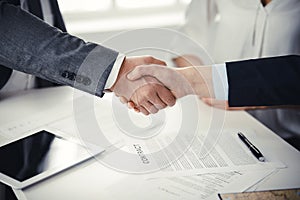 Business people shaking hands finishing contract signing, close-up. Business communication concept. Handshake and