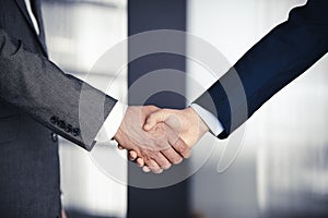 Business people shaking hands finishing contract signing, close-up. Business communication concept. Handshake and