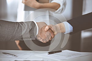 Business people shaking hands finishing contract signing, close-up. Business communication concept. Handshake and