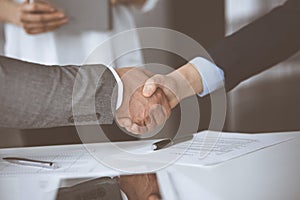 Business people shaking hands finishing contract signing, close-up. Business communication concept. Handshake and