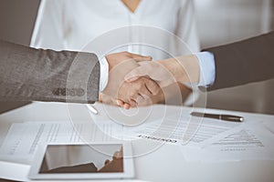 Business people shaking hands finishing contract signing, close-up. Business communication concept. Handshake and