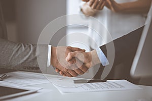 Business people shaking hands finishing contract signing, close-up. Business communication concept. Handshake and