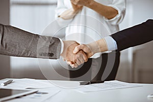 Business people shaking hands finishing contract signing, close-up. Business communication concept. Handshake and