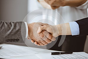 Business people shaking hands finishing contract signing, close-up. Business communication concept. Handshake and