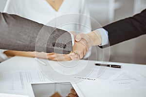 Business people shaking hands finishing contract signing, close-up. Business communication concept. Handshake and