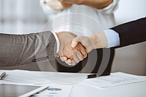 Business people shaking hands finishing contract signing, close-up. Business communication concept. Handshake and