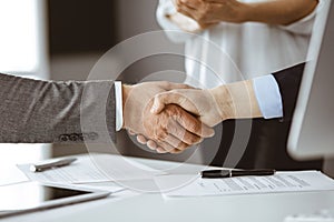 Business people shaking hands finishing contract signing, close-up. Business communication concept. Handshake and