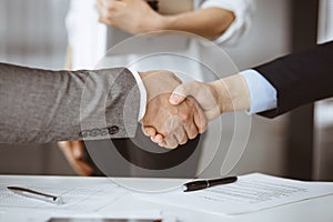 Business people shaking hands finishing contract signing, close-up. Business communication concept. Handshake and