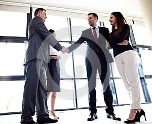 Business people shaking hands, finishing up meeting