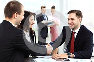 Business people shaking hands, finishing up meeting