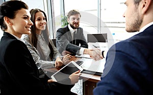 Business people shaking hands, finishing up meeting