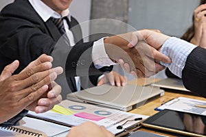 Business people shaking hands after finishing up a meeting. Businessman handshaking after conference. teamwork, partnership, coll