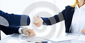 Business people shaking hands finishing up a meeting , close-up. Success at negotiation and handshake concepts. Group of