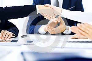 Business people shaking hands finishing up a meeting , close-up. Success at negotiation and handshake concepts. Group of