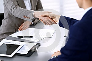 Business people shaking hands, finishing up a meeting. Papers signing, agreement and lawyer consulting concept