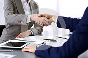 Business people shaking hands, finishing up a meeting. Papers signing, agreement and lawyer consulting concept