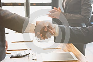 Business people shaking hands after finishing up a meeting. Two