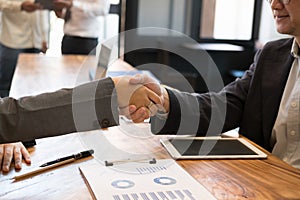 Business people shaking hands after finishing up a meeting. Two