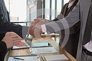 Business people shaking hands after finishing up a meeting. Two