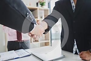 Business people shaking hands, finishing up a meeting. Two confident business man shaking hands during a meeting in the office,