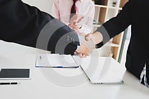 Business people shaking hands, finishing up a meeting. Two confident business man shaking hands during a meeting in the office,