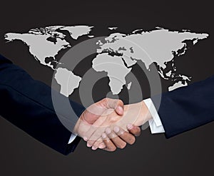 Business with people shaking hands with a global background