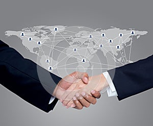 Business with people shaking hands with a global communication