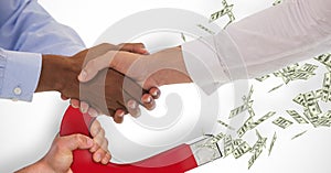 Business people shaking hands while magnet pulling money in background