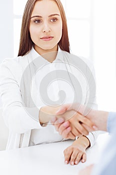 Business people shaking hands at meeting or negotiation after contract discussing. Businessman and woman handshake at
