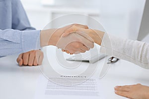 Business people shaking hands at meeting or negotiation after contract discussing. Businessman and woman handshake at office while
